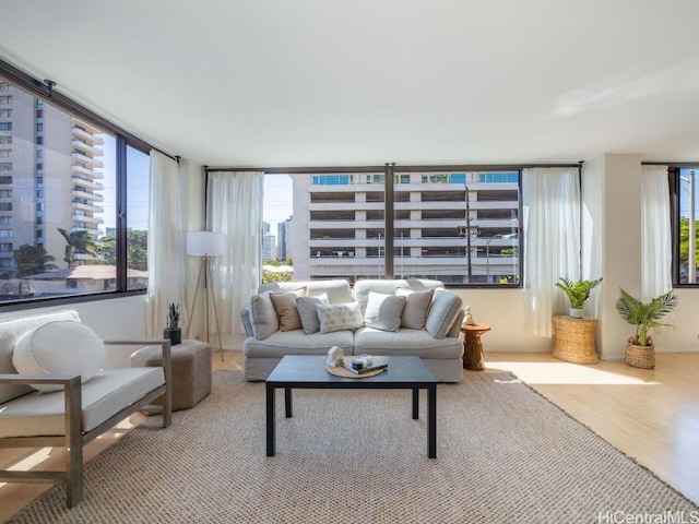 living area with a view of city and light wood finished floors