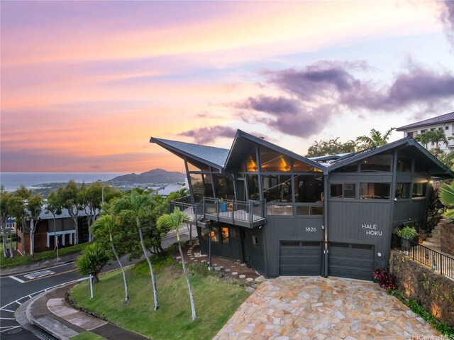 1826 Laukahi St, Honolulu, HI 96821 - view of front of property featuring an attached garage, driveway, a balcony, and a front yard