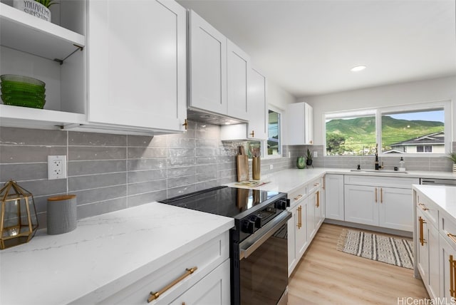 kitchen featuring white cabinetry, black electric range oven, and open shelves