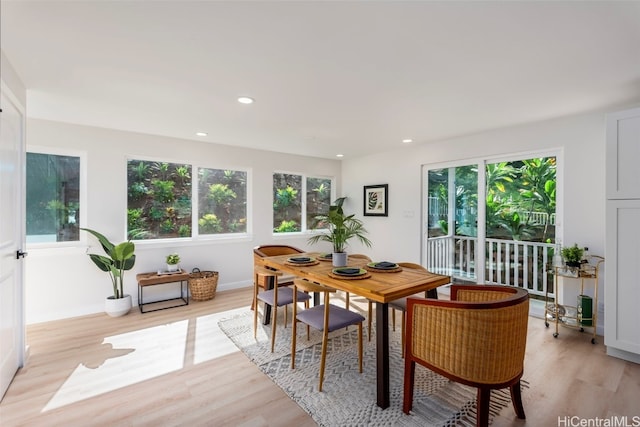 dining area with light wood finished floors, plenty of natural light, and recessed lighting