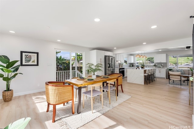 dining area featuring light wood-style floors, a wealth of natural light, and recessed lighting