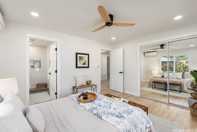 bedroom featuring light wood-style floors, recessed lighting, and a wall unit AC