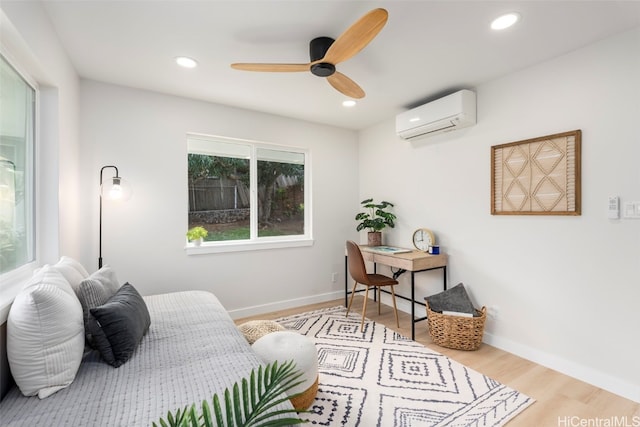 bedroom with baseboards, light wood-type flooring, a wall mounted air conditioner, and recessed lighting