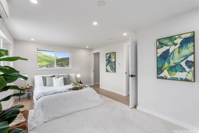 bedroom with baseboards, light wood-style floors, and recessed lighting