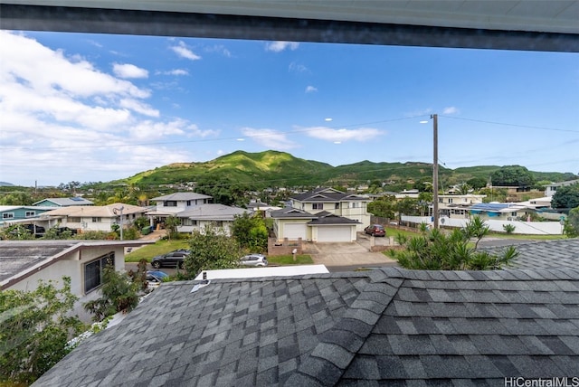 exterior details featuring a shingled roof, a residential view, and a mountain view