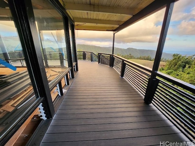 deck at dusk featuring a mountain view