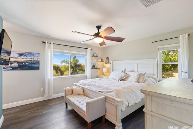 bedroom with ceiling fan, dark wood-style flooring, baseboards, and visible vents
