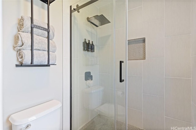 bathroom featuring a shower stall and toilet