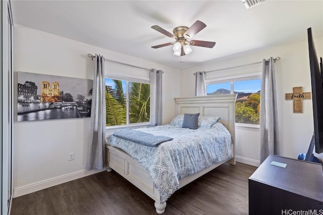 bedroom with dark wood-type flooring, baseboards, and ceiling fan