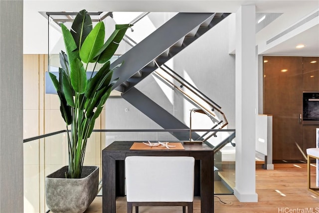 dining area featuring stairway and wood finished floors