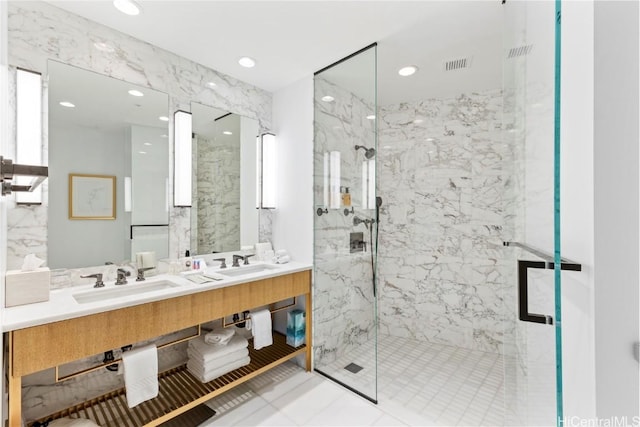 full bathroom featuring a sink, a marble finish shower, recessed lighting, and double vanity