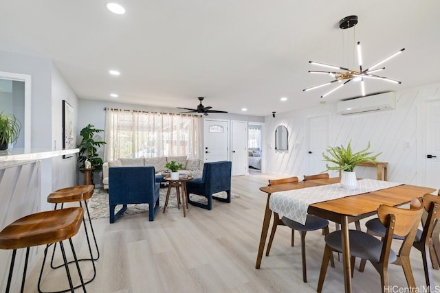 dining room featuring light wood-type flooring, ceiling fan, an AC wall unit, and recessed lighting