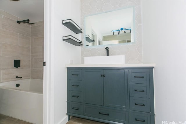 bathroom featuring shower / bath combination, vanity, and decorative backsplash