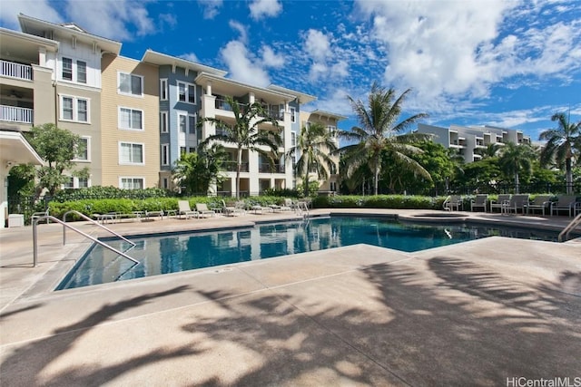 community pool featuring a patio area and fence