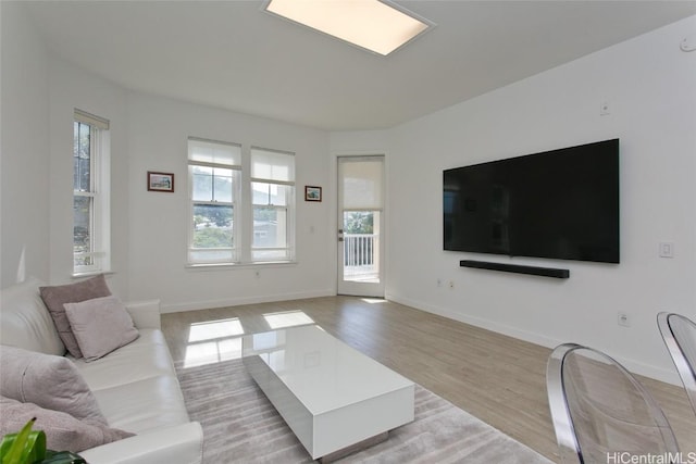 living room featuring light wood-style flooring and baseboards