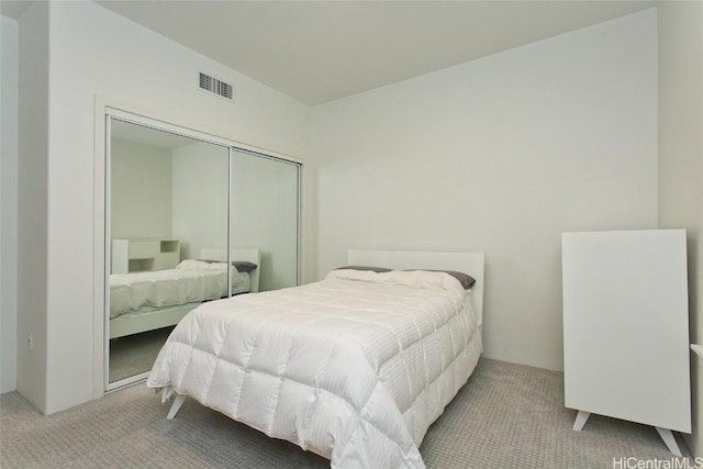 bedroom with carpet, a closet, and visible vents