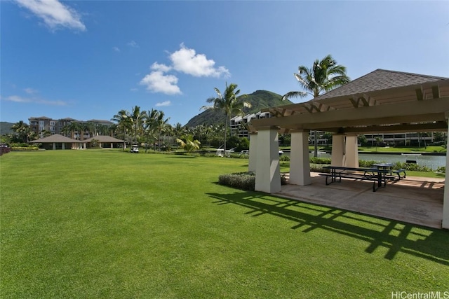 view of property's community featuring a yard, a gazebo, and a patio