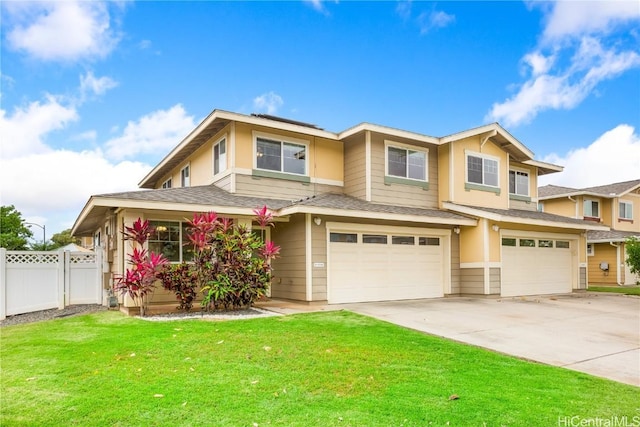 view of front of house with fence, concrete driveway, a front yard, a shingled roof, and an attached garage