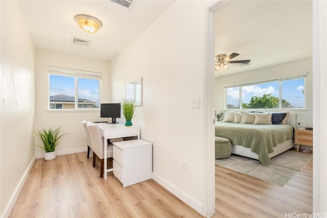 office featuring visible vents, baseboards, and light wood-style floors