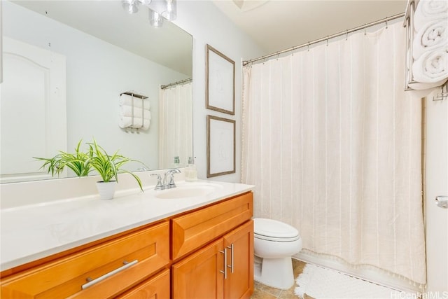 bathroom featuring vanity, a shower with shower curtain, toilet, and tile patterned floors