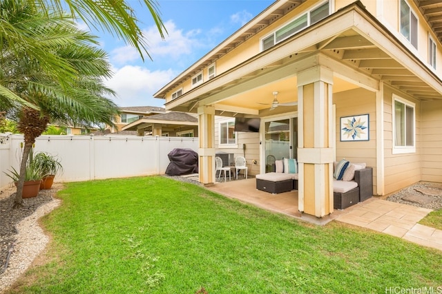 rear view of property with a yard, a patio, a fenced backyard, and a ceiling fan