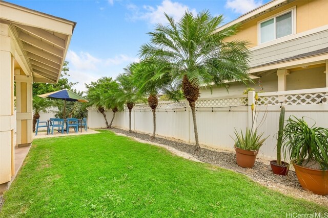 view of yard with a fenced backyard and a patio area