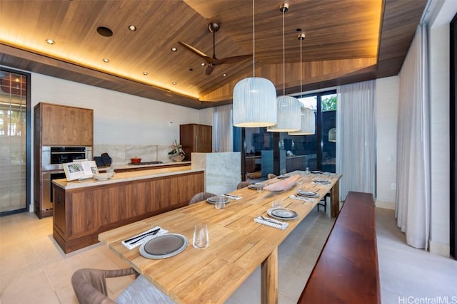 kitchen with brown cabinetry, wooden ceiling, light countertops, and light tile patterned floors