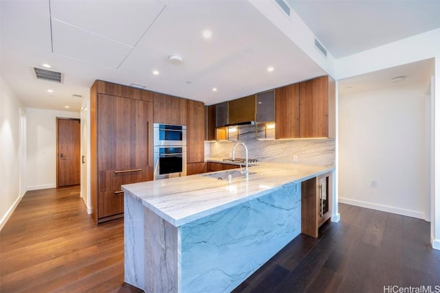 kitchen featuring modern cabinets, visible vents, brown cabinets, and stainless steel double oven