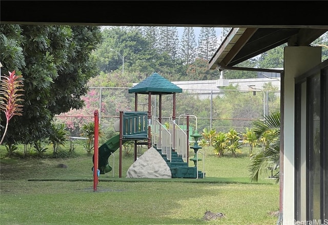 community play area with a yard and fence