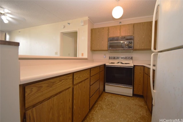 kitchen with a textured ceiling, light countertops, white appliances, and brown cabinets