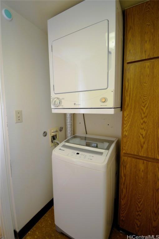 washroom with laundry area and stacked washer and clothes dryer