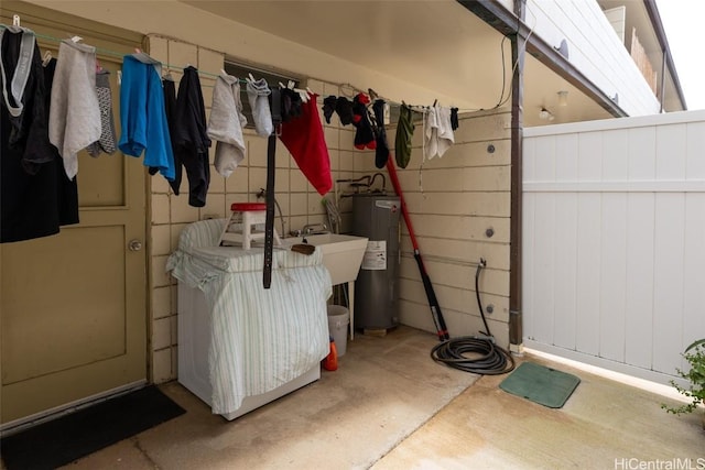 interior space featuring water heater, a sink, and fence