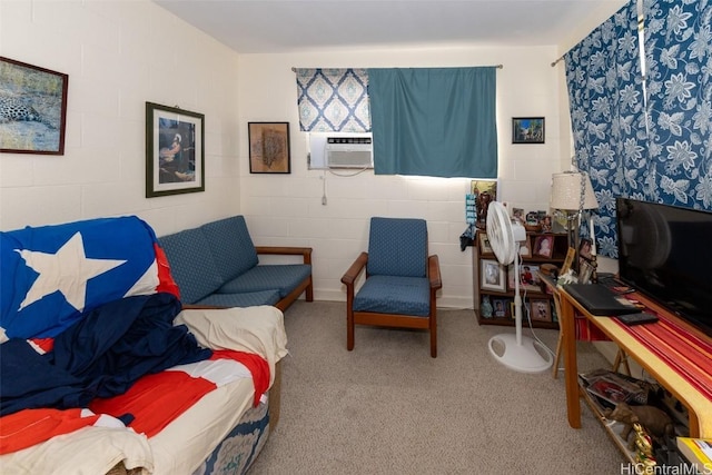 interior space with light carpet, cooling unit, and concrete block wall