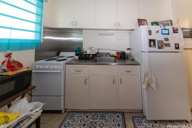 kitchen featuring stainless steel countertops, backsplash, white cabinets, a sink, and white appliances