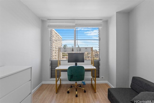 office area with light wood-style flooring and baseboards