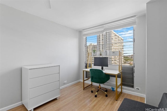 office space featuring baseboards and wood finished floors