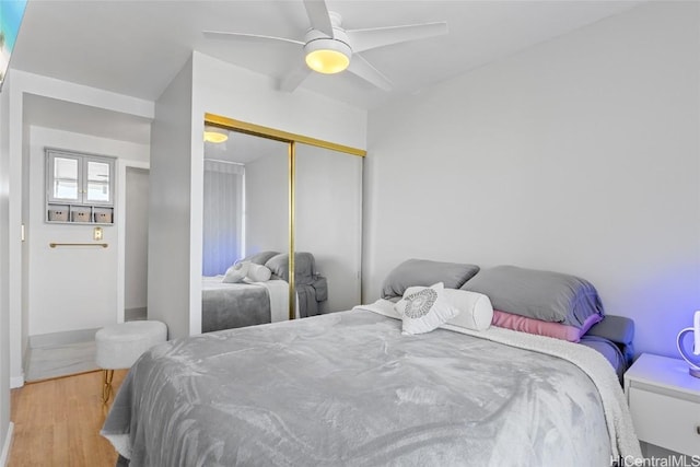 bedroom featuring a closet, ceiling fan, and wood finished floors