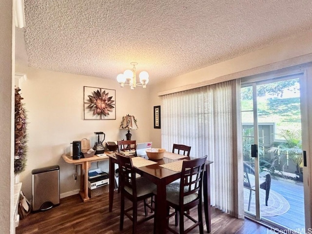 dining space with baseboards, dark wood-style flooring, a textured ceiling, and a notable chandelier