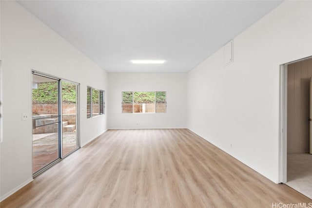 spare room featuring light wood-type flooring