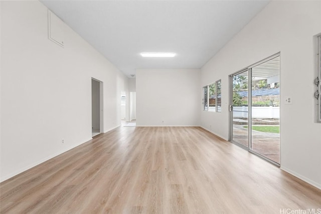 spare room with light wood finished floors and baseboards