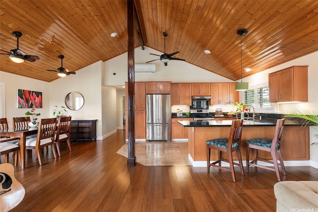 66-158A Haleiwa Rd, Haleiwa, HI 96712 - kitchen with appliances with stainless steel finishes, a wall mounted air conditioner, ceiling fan, dark countertops, and a peninsula