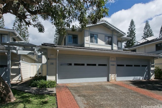 view of front of house with an attached garage, fence, and aphalt driveway