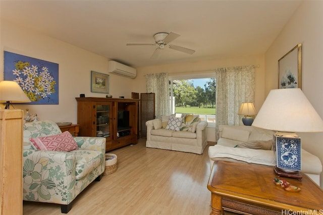 living room with a ceiling fan, an AC wall unit, and wood finished floors