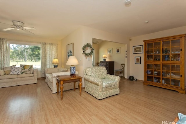 living room with light wood-style floors and ceiling fan