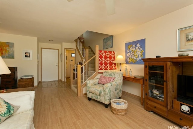 living area featuring stairs and wood finished floors