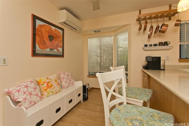 interior space featuring a wall unit AC and light wood-style flooring