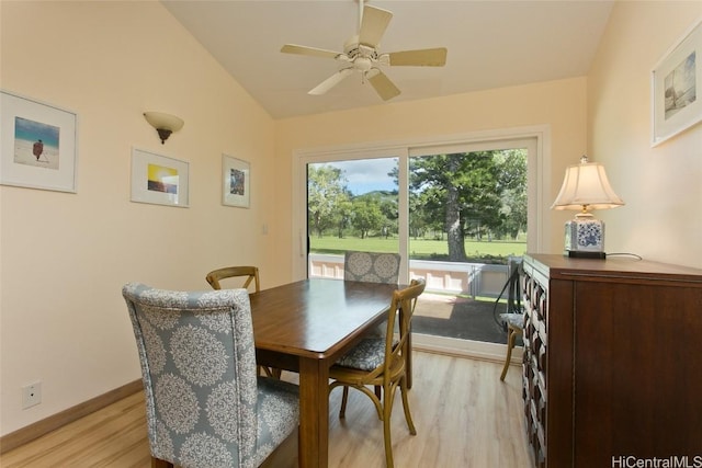 dining area featuring lofted ceiling, light wood-type flooring, a ceiling fan, and baseboards