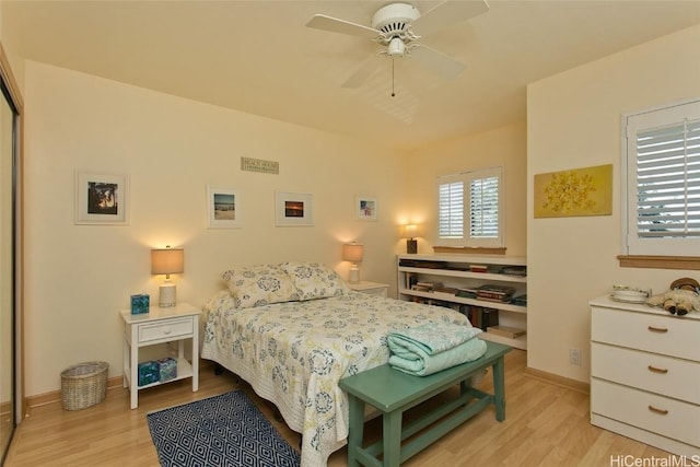 bedroom featuring light wood finished floors, ceiling fan, and baseboards