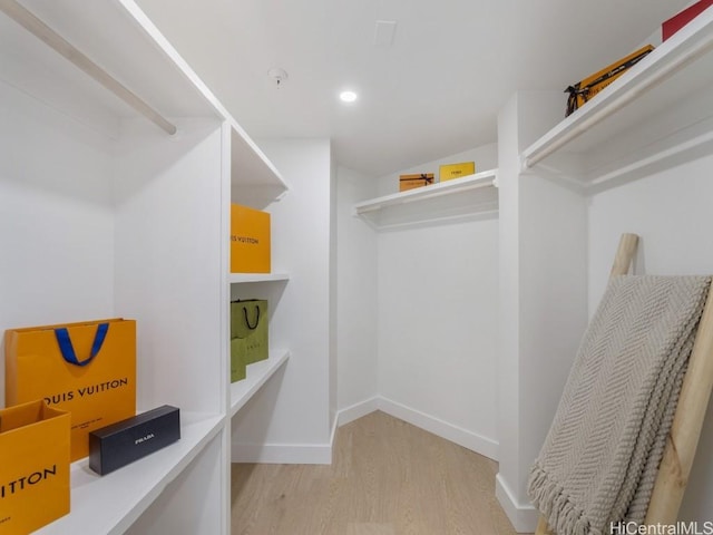 walk in closet featuring light wood-style flooring