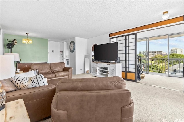 1325 Wilder Ave Unit 5, Honolulu, HI 96822 - carpeted living room with a chandelier and a textured ceiling